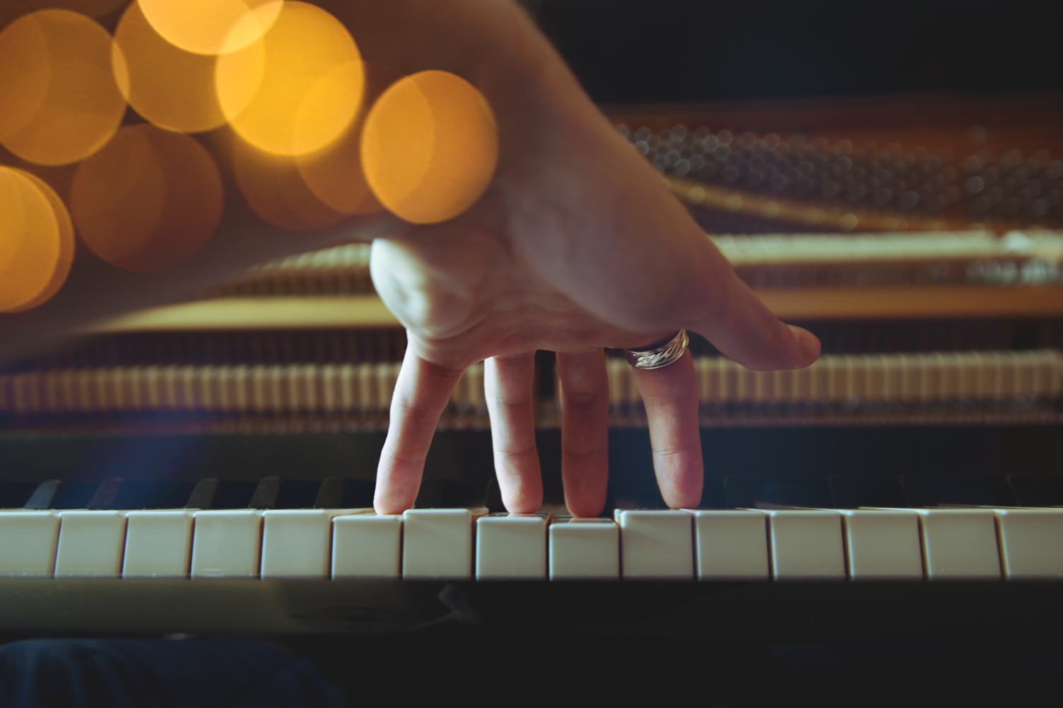 Close Up of Left Hand of a Young Woman Playing Piano