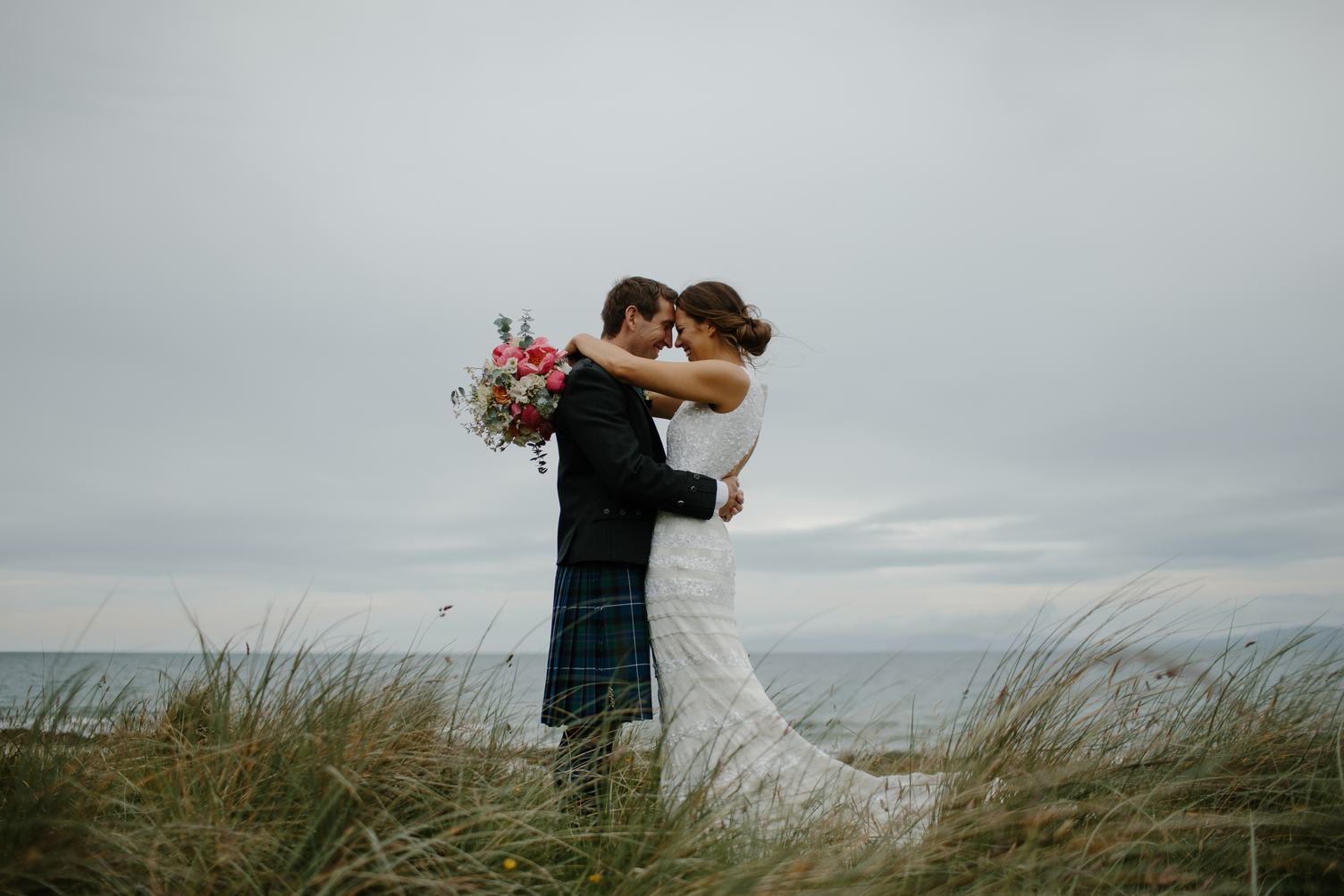 Happy and Lovely Wedding Couple Cuddling on the Beach
