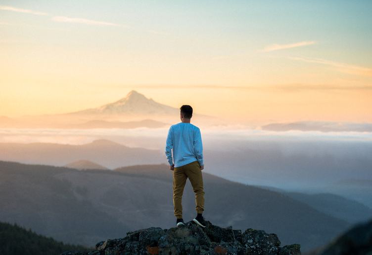 Man Standing on a Peak and Admire the Views