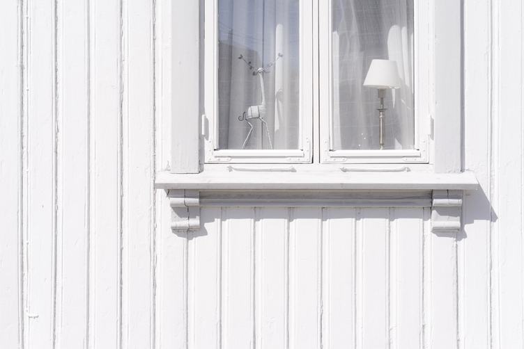White Wall of an Old Wooden House with Window