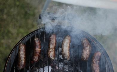 Grilling Sausages on Barbecue Grill Outdoors