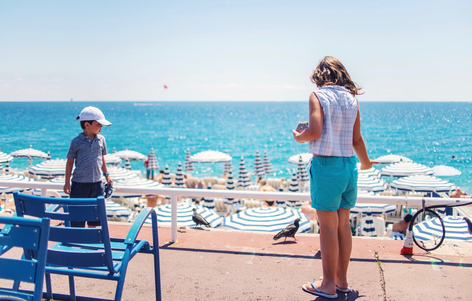 Summer Vacation Children Feeding Pigeons on the Beach