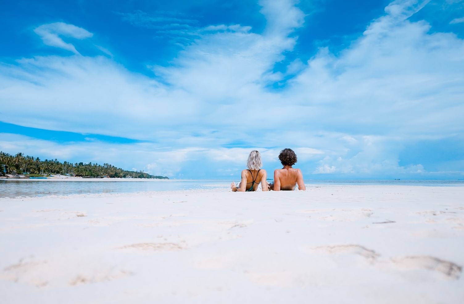 Beautiful Tropical Landscape Young Couple Lying on a Beach