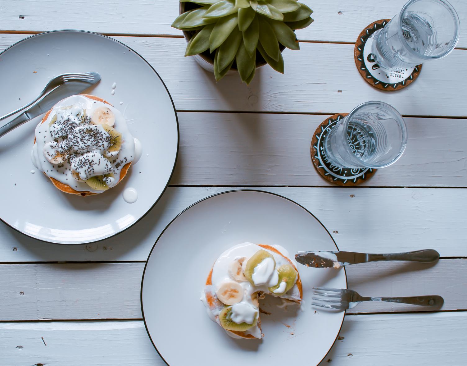 Pancakes with Yoghurt, Kiwi and Banana on Wooden Background Top View