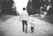 Father and Little Boy Walking Down the Street