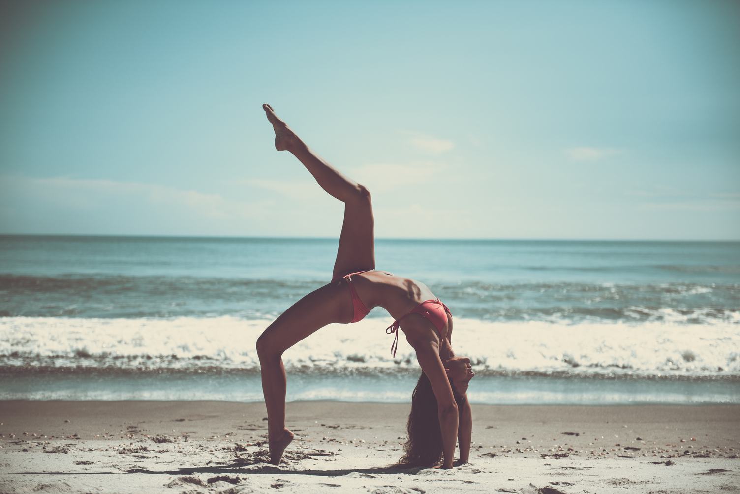 Attractive Woman in Bikini Doing Yoga at the Sea
