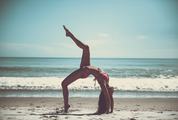 Attractive Woman in Bikini Doing Yoga at the Sea