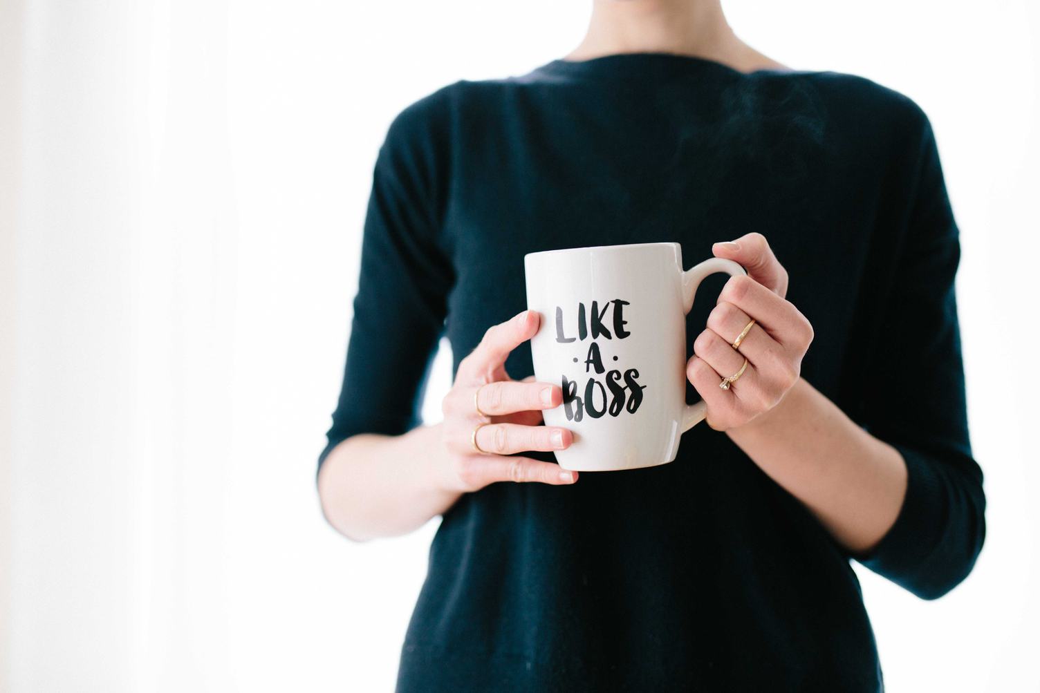 Woman Is Holding a Cup of Coffee