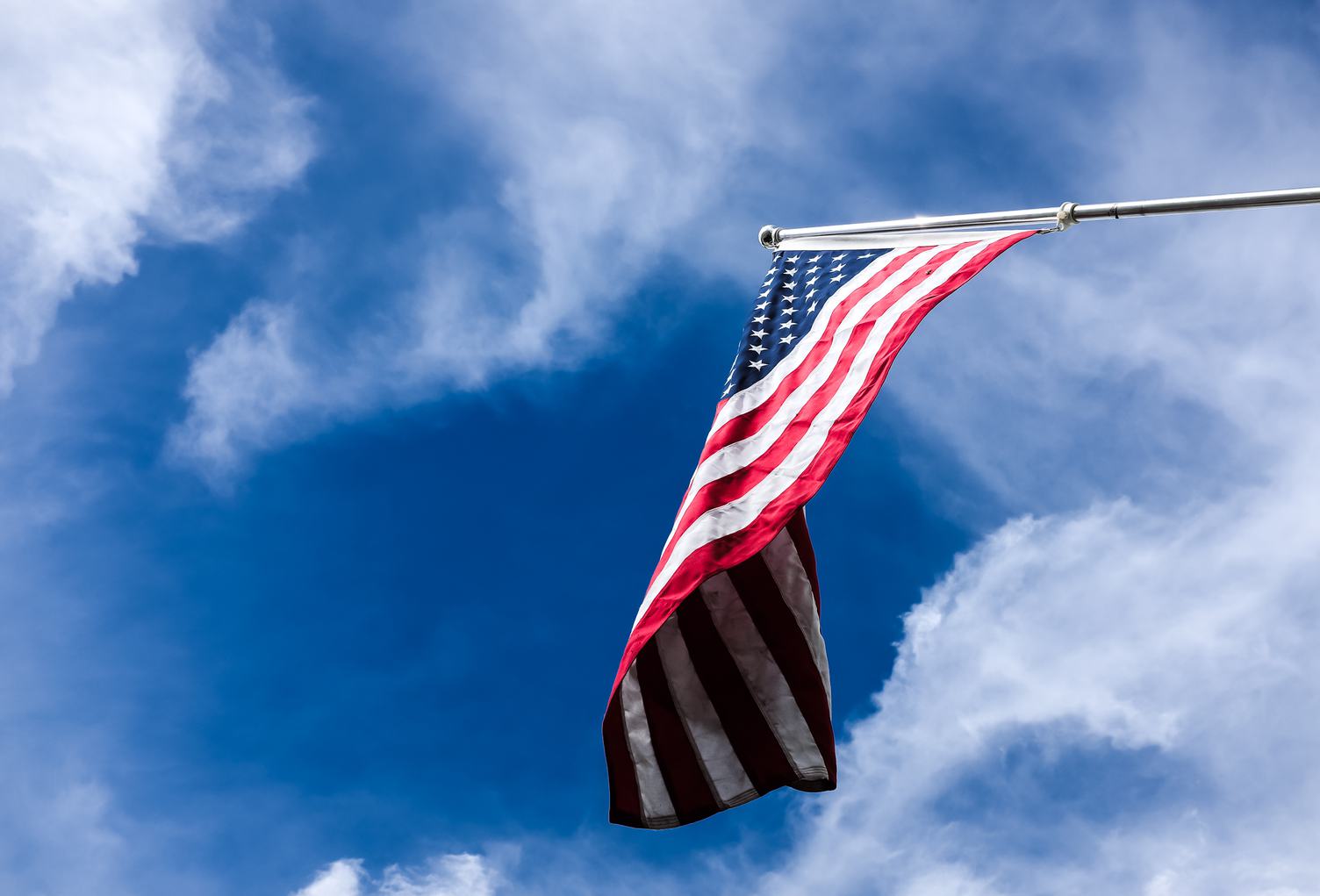 Flag of the United States on the Blue Sky
