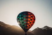 Colorful Hot Air Balloon Flying over Mountains