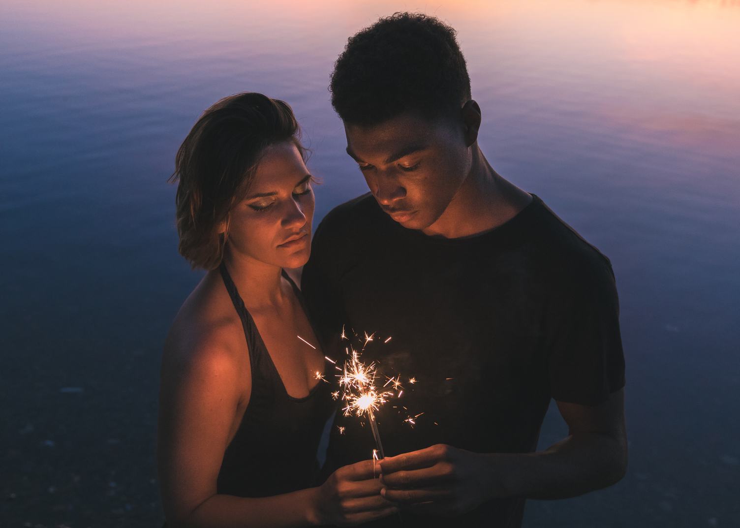 Couple of Young People Holding Bengal Light