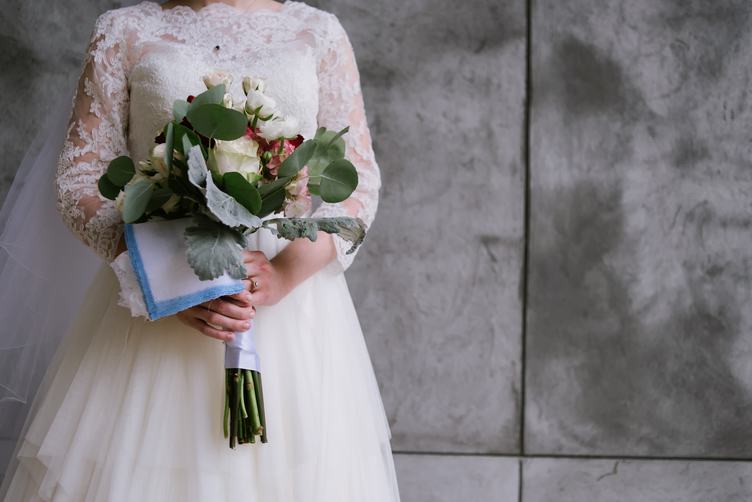 Bride in White Dress with Bouquet of Flowers