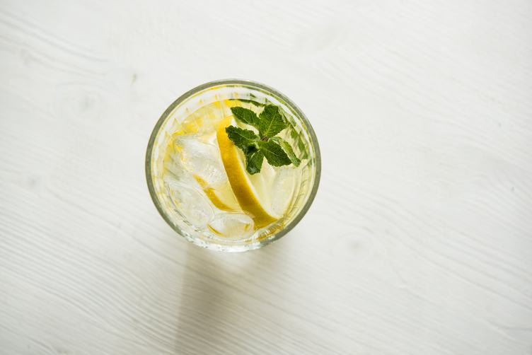Water with Fresh Lemon, Mint and Ice on Wooden Background