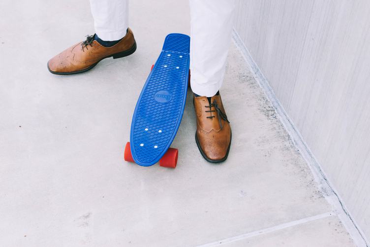 Man Standing Near Blue Skateboard