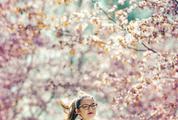 Girl Walking Among Flowering Cherries