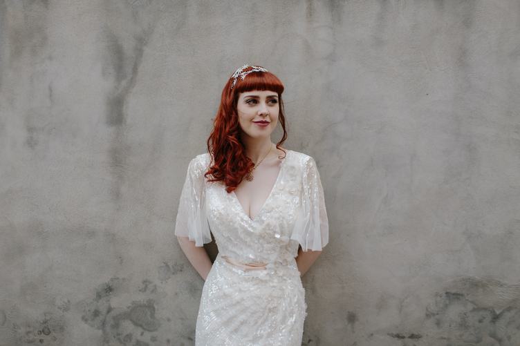 Bride with Red Hair Against Gray Wall