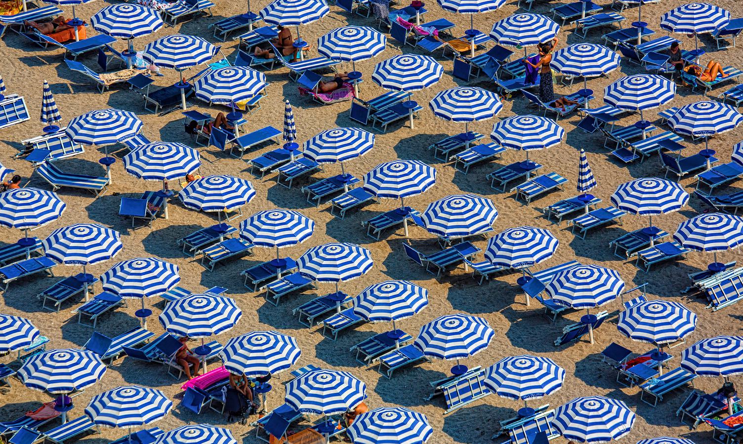 Plenty of Striped Umbrellas on the Beach