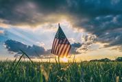 American Flag on the Field against Sunset