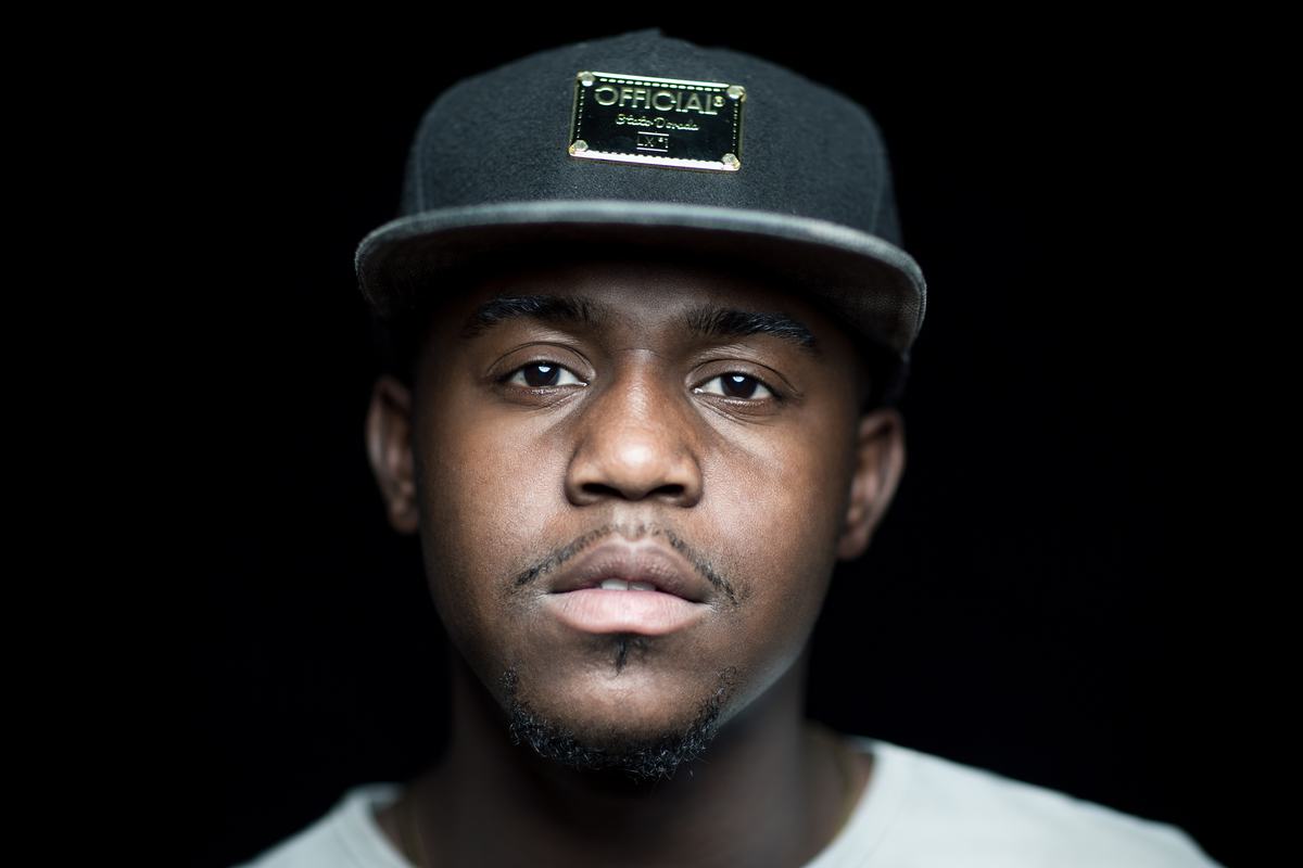 Free Photo Portrait of Young Man with Cap On Black Background