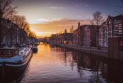 Houses and Boats near Amsterdam Canal at Sunrise