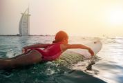 Little Girl Surf against Burj al Arab Building, Dubai