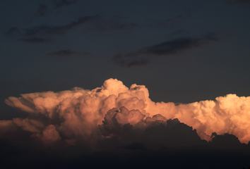 Cumulus Clouds against Dark Sky