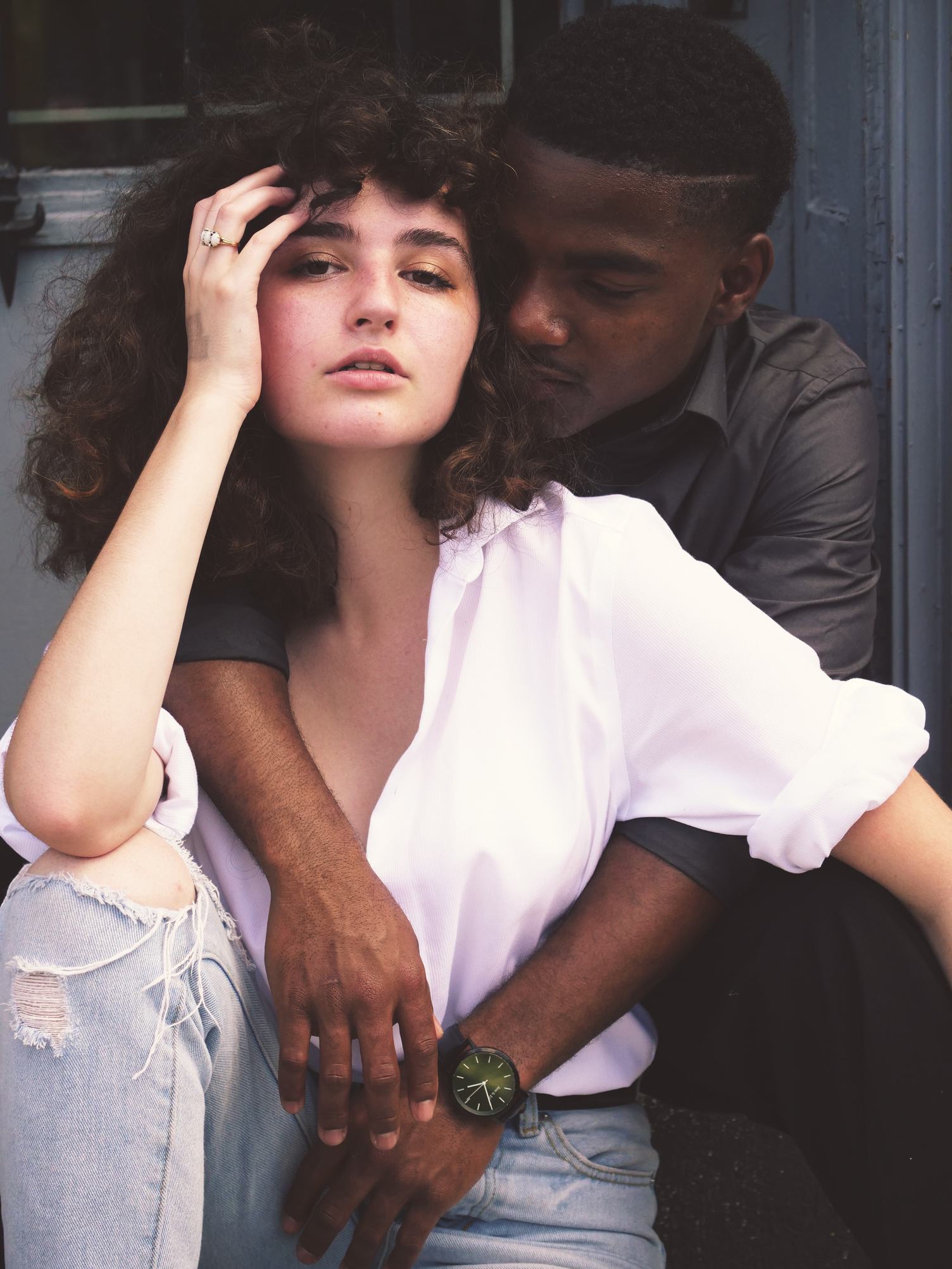 Portrait of Young Man Embracing His Girlfriend from behind
