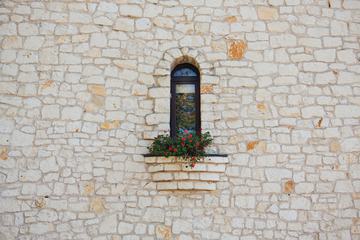 Stone Wall and Window with Red Geranium