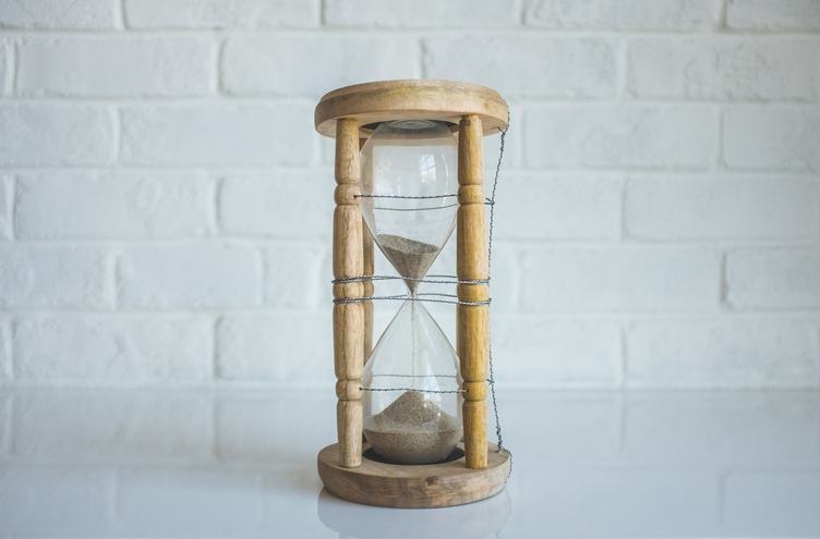 Wooden Hourglass against White Wall