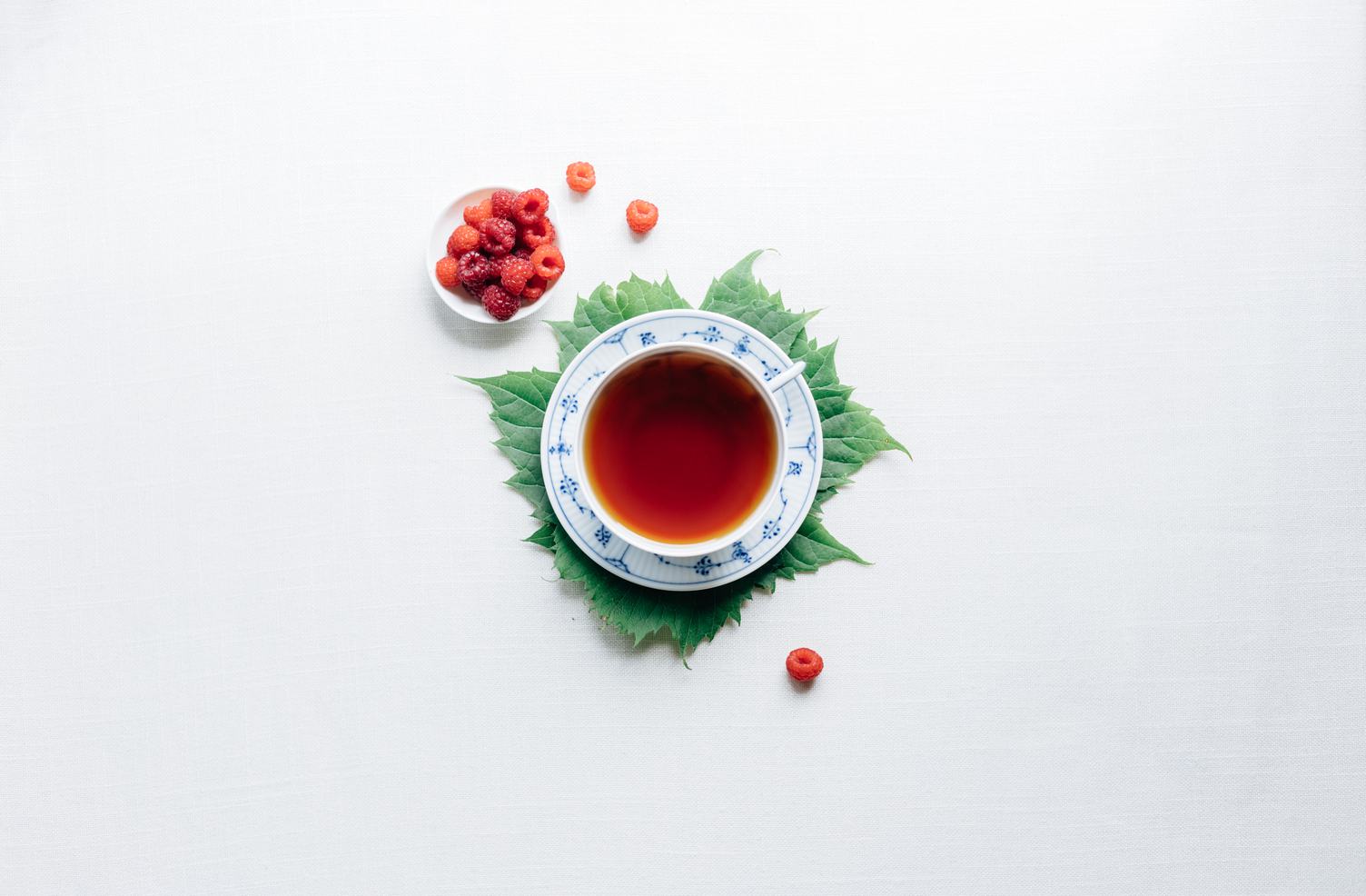 Tea in Porcelain Cup with Raspberries, Flair Lay