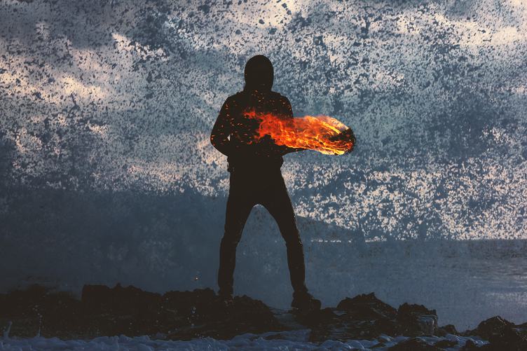 Mysterious Person Holding Fire Torch against Splashing Waves
