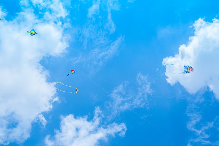 Kite and Parachute on Blue Sky