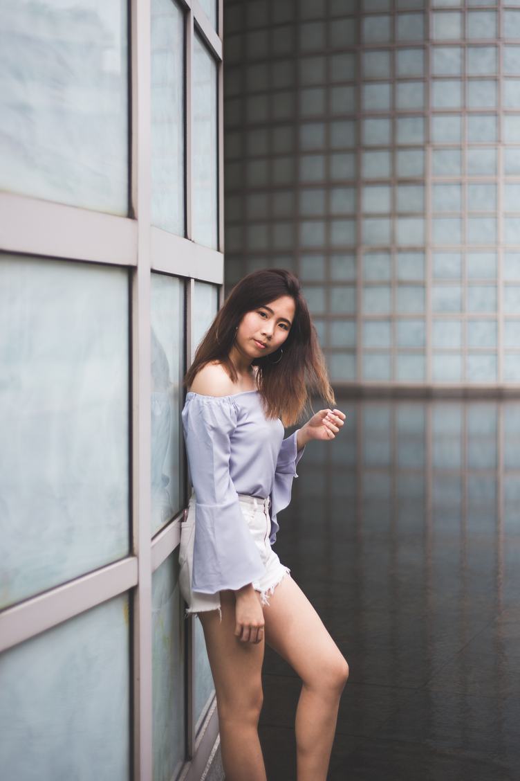 Asian Woman Posing Leaning against the Wall