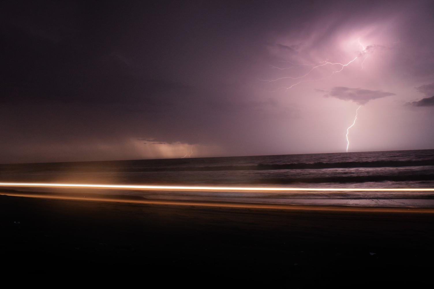 Dark Night with Lightning above Violet Sea