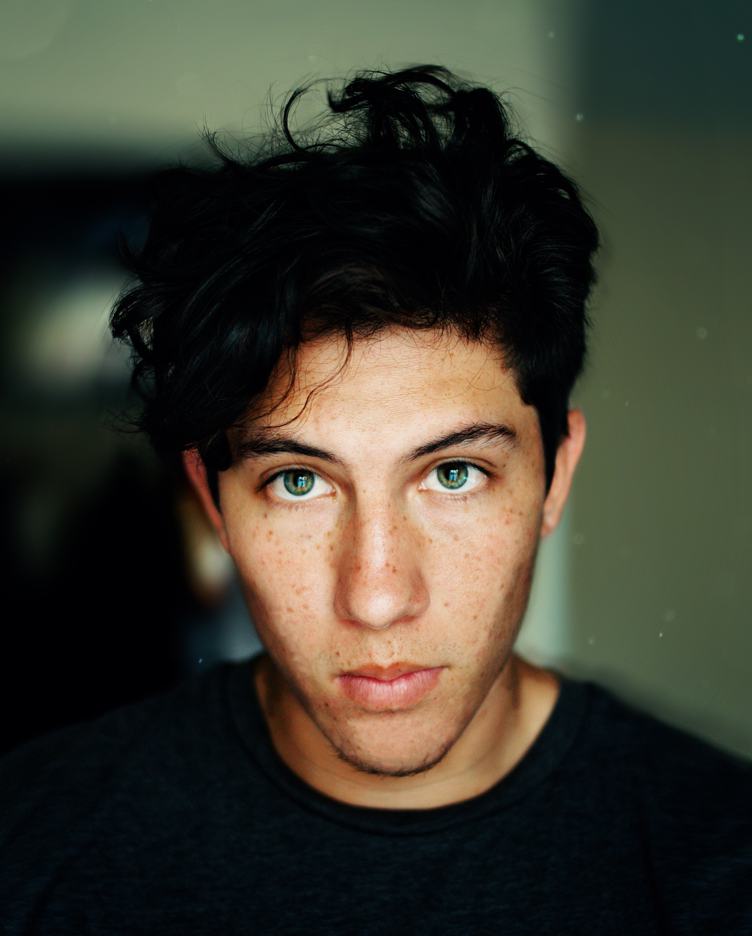 Young Man with Green Eyes and Freckles