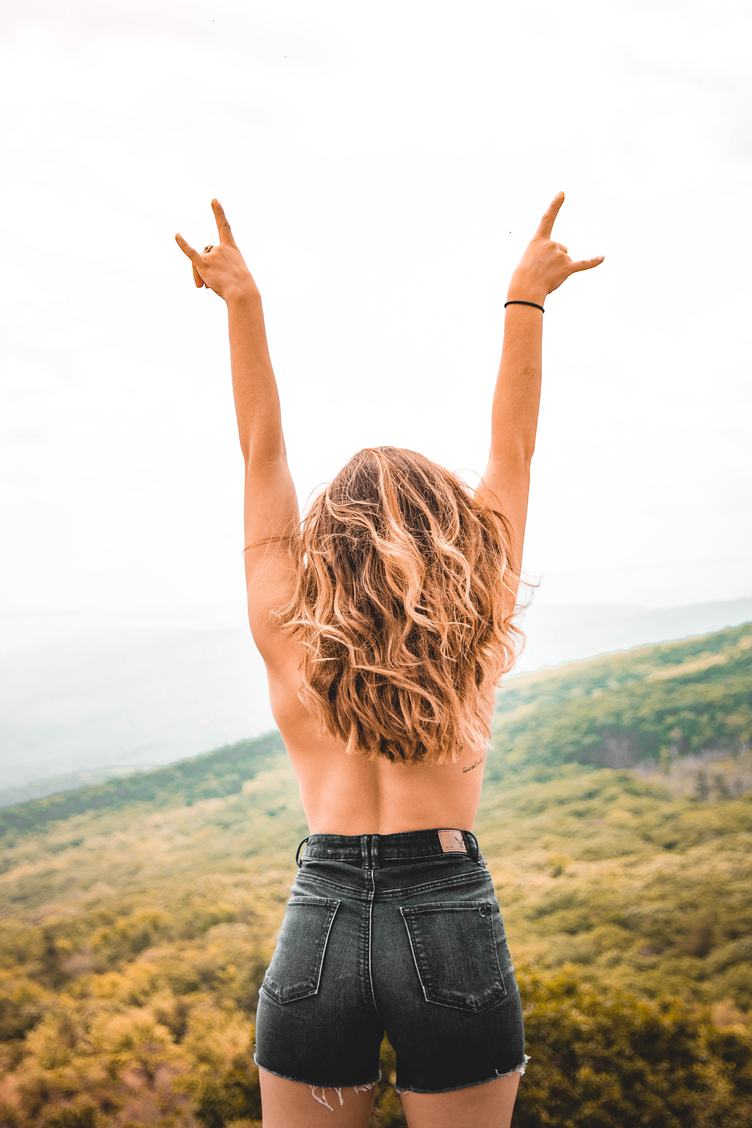Blonde Woman with Bare Back in Black Denim Shorts Stand with Their Hands Up
