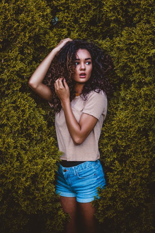 Free Photo: Portrait of Pretty Woman with Long Curly Hair Outdoors
