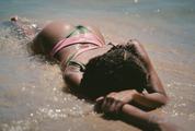 Woman Lying in the Water, Cooling on a Beach