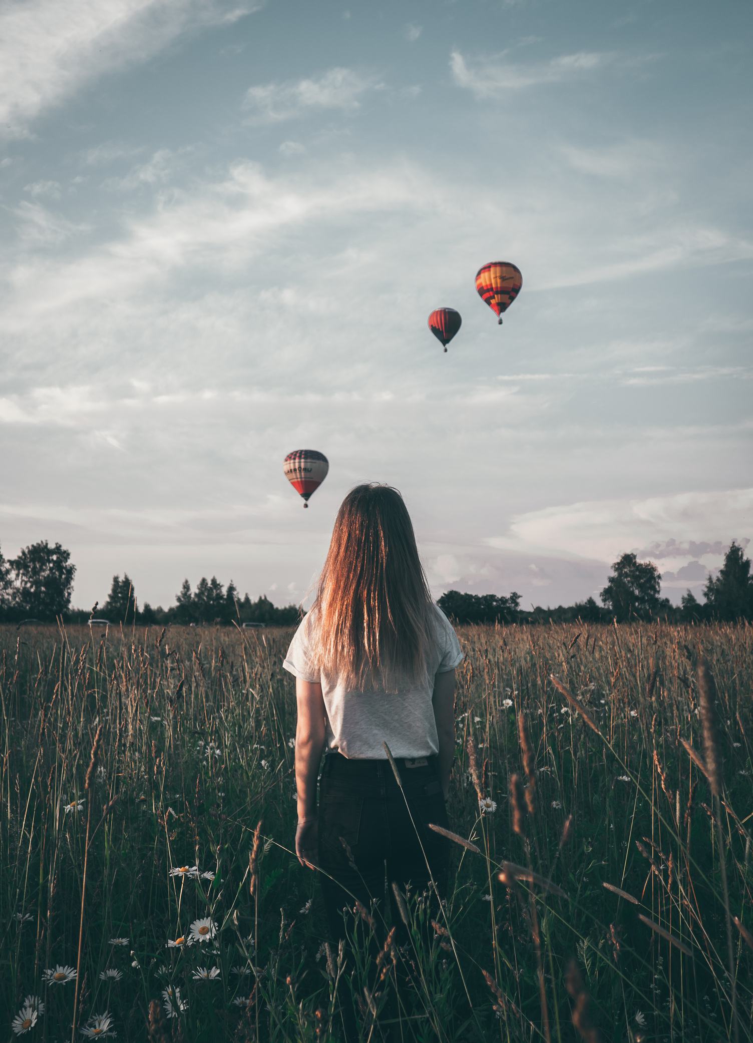 Girl looking at Three Colorful Hot Air Balloons