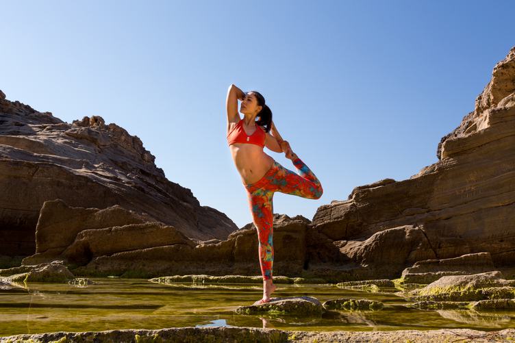 Woman Doing Yoga on a Rocky Seashore, Mallorca, Spain