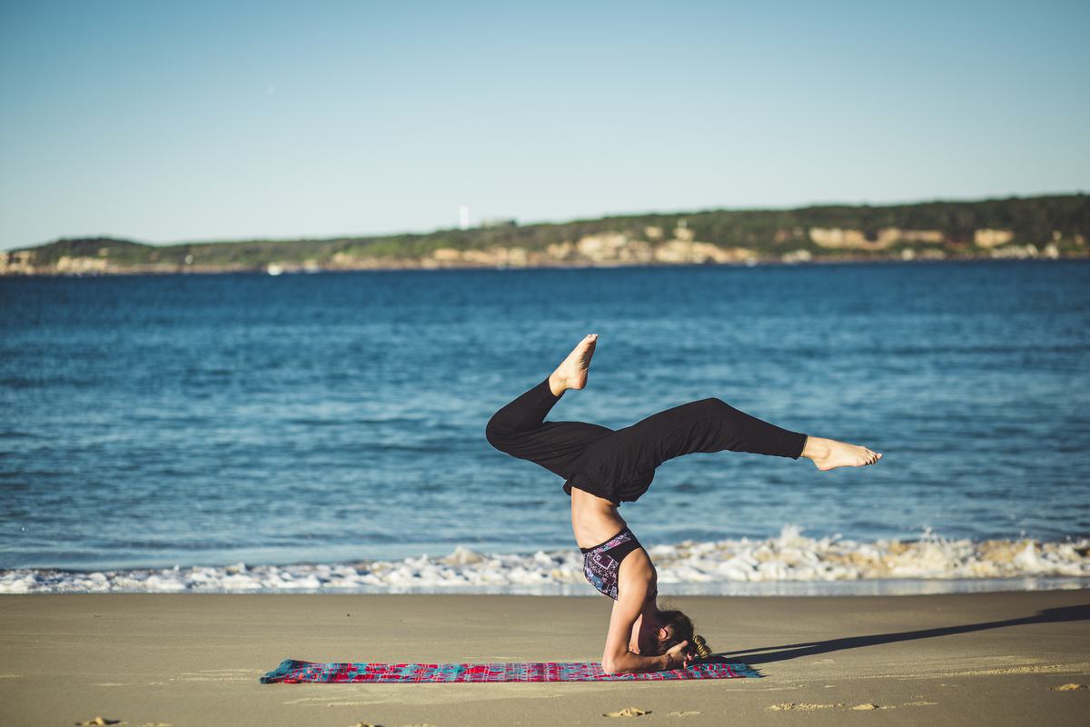 Free Photo Young Woman Does Yoga on the Beach