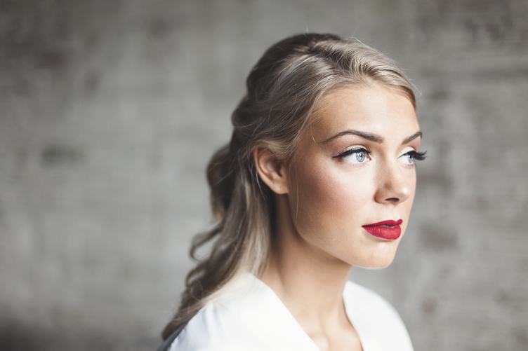 Portrait of Caucasian Blonde Woman with red Lips and Artificial Eyelashes