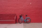 Blue Bicycle against Red Brick Wall