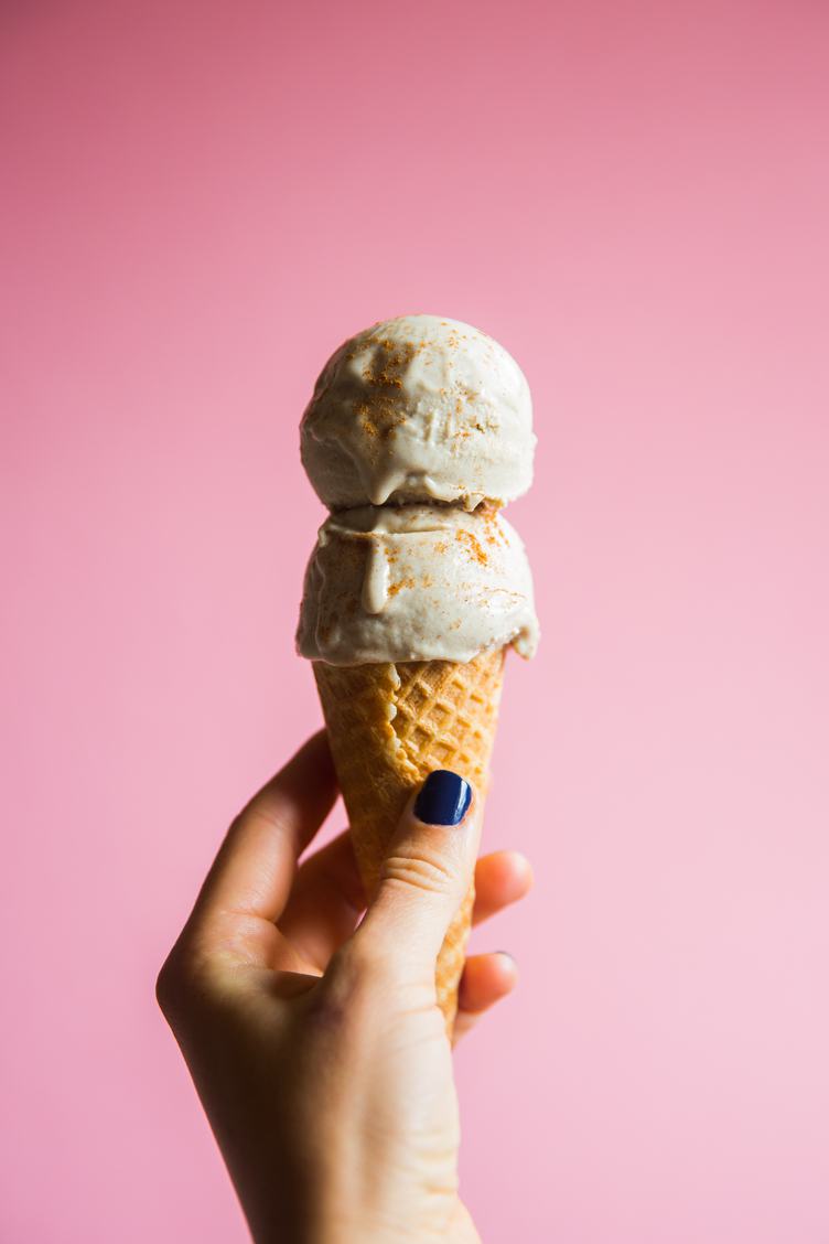 Female Hand Holding Ice Cream in Waffle Cone