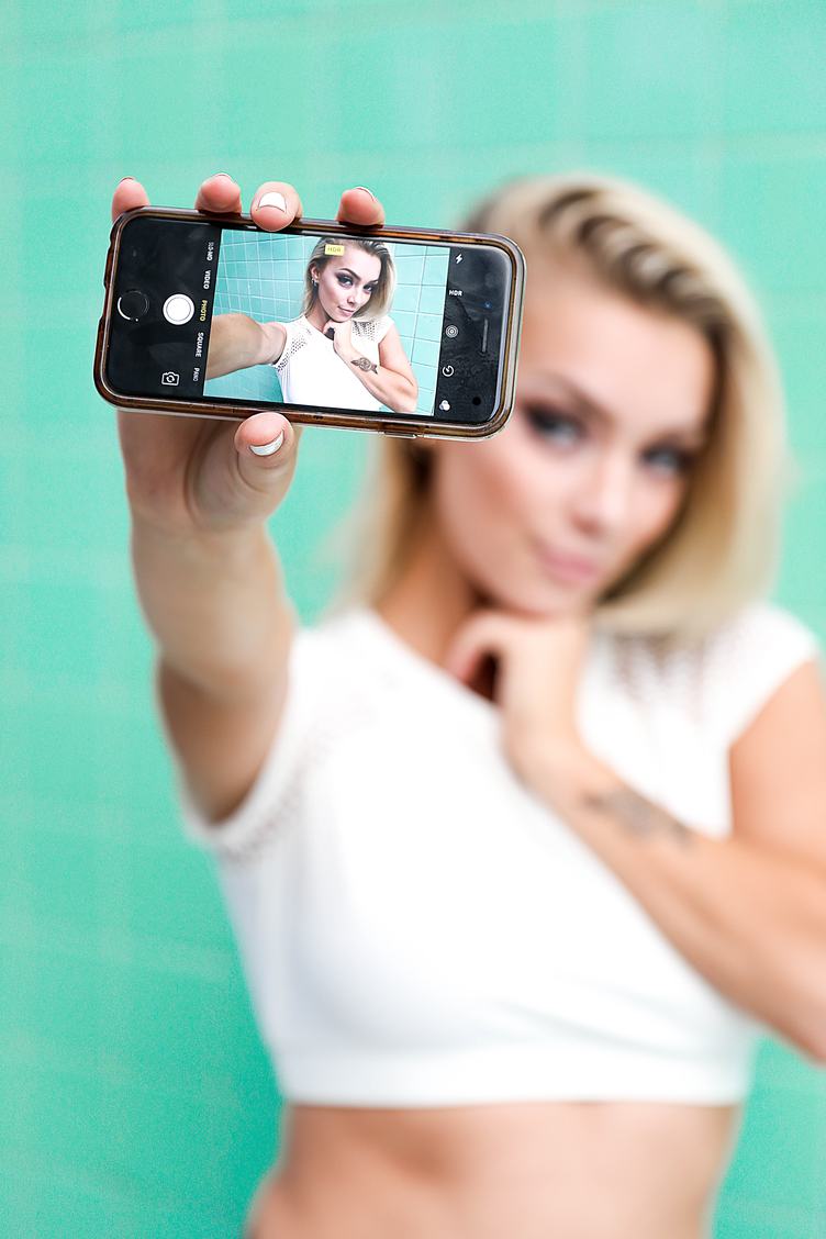 Blonde Girl Showing Selfie on Her Smartphone