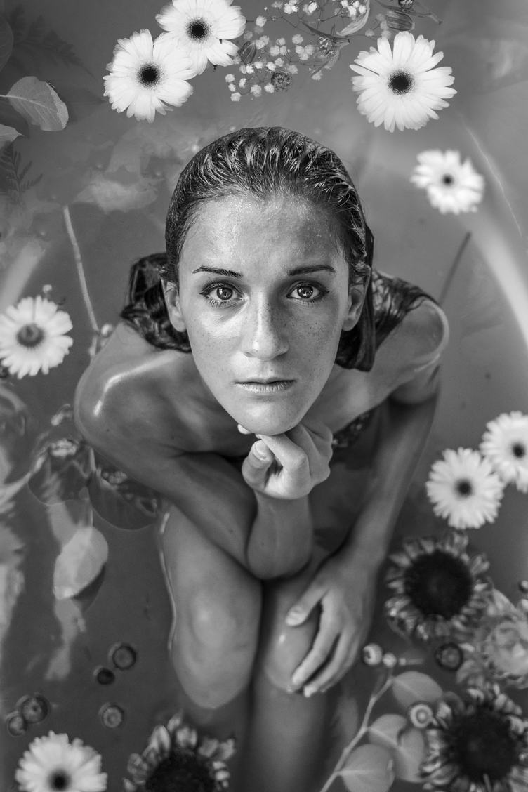 Beautiful Young Woman Having Bath with Flowers