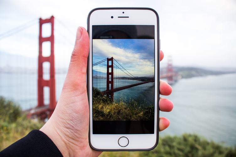 Person Taking Picture with iPhone of the Golden Gate Bridge