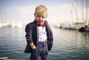 Little Boy Wearing Elegant Jacket with Red Bow Tie