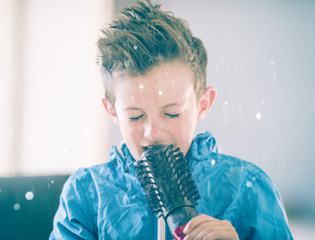 Little Boy Singing Using a Hairbrush as Microphone