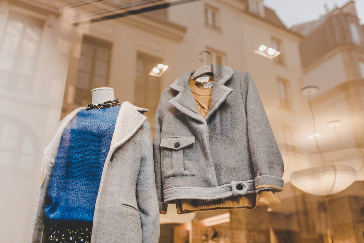 Boutique Window with Hangers and Gray Jackets